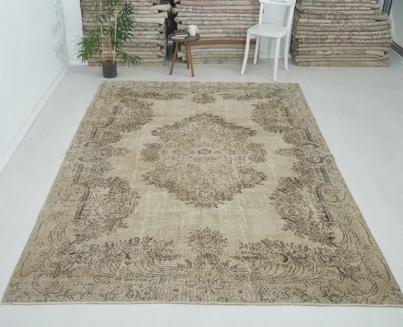 Large vintage-style beige rug with traditional floral patterns.
