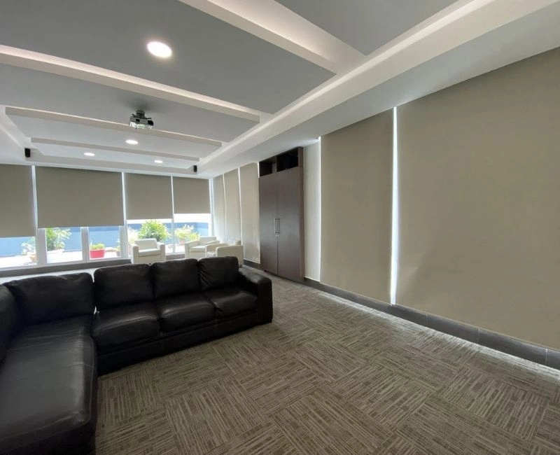 Blackout roller blinds for modern Dubai office windows.