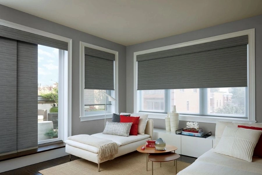 Modern charcoal grey roller blinds in Dubai lounge.