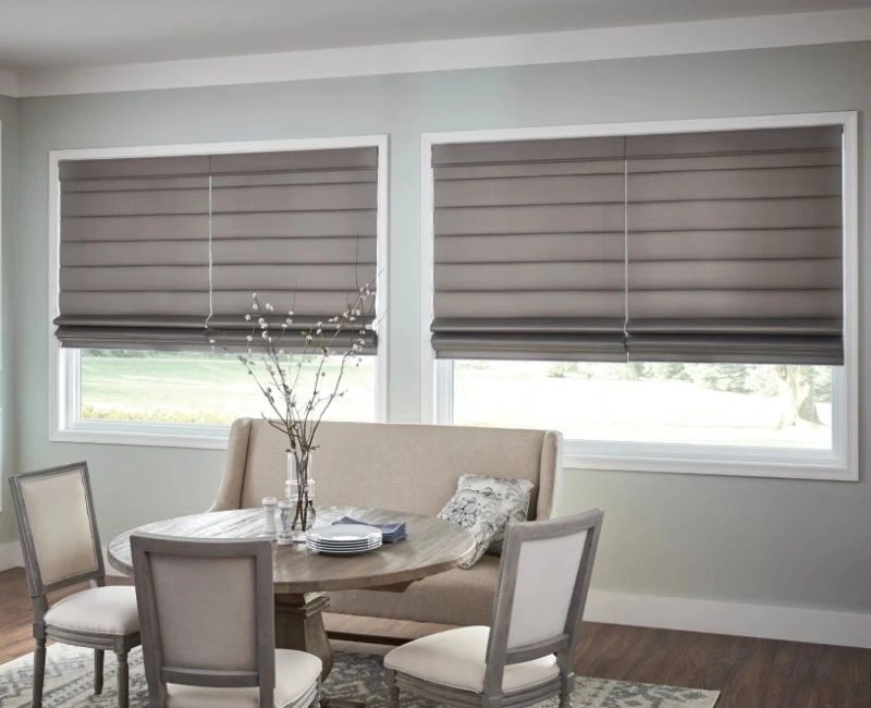 Elegant grey roman blinds for Dubai dining room windows.