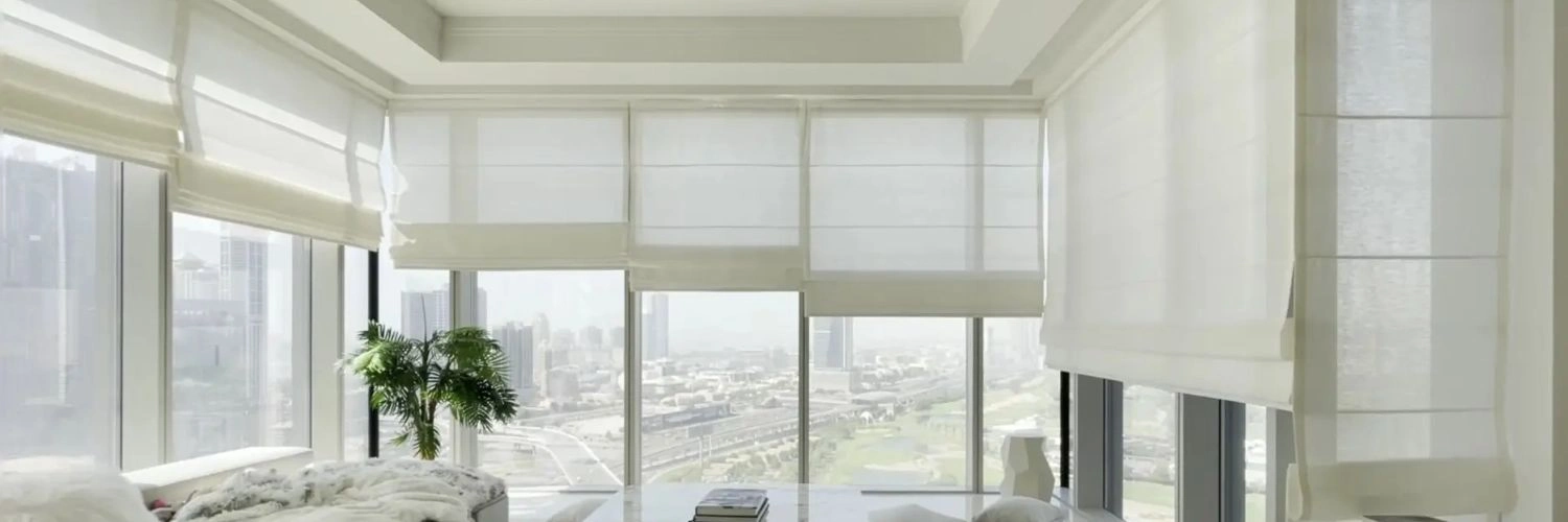 Luxury white roman blinds in modern Dubai apartment.
